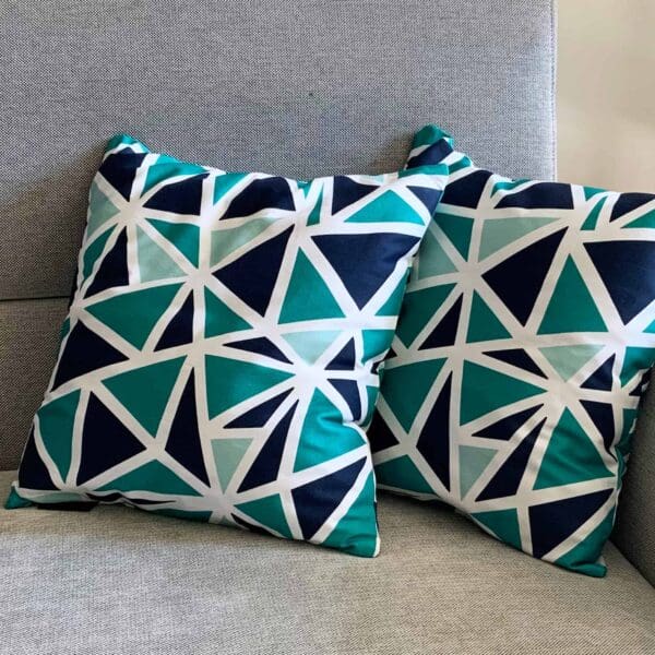 Close up of two blue triangle pattern cushions