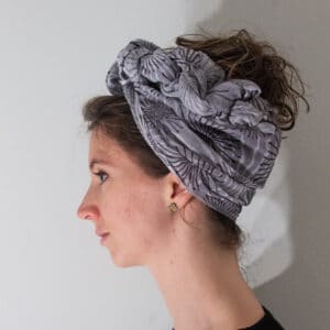 grey scarf or turban/headscarf with white and dark purple designs