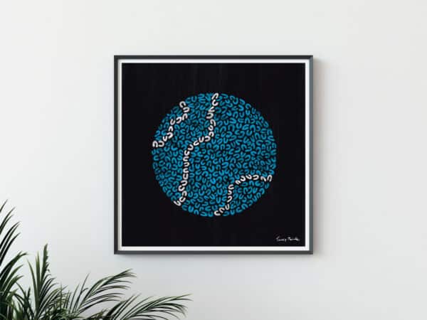 black art print in frame with blue and white circle drawn in U shapes