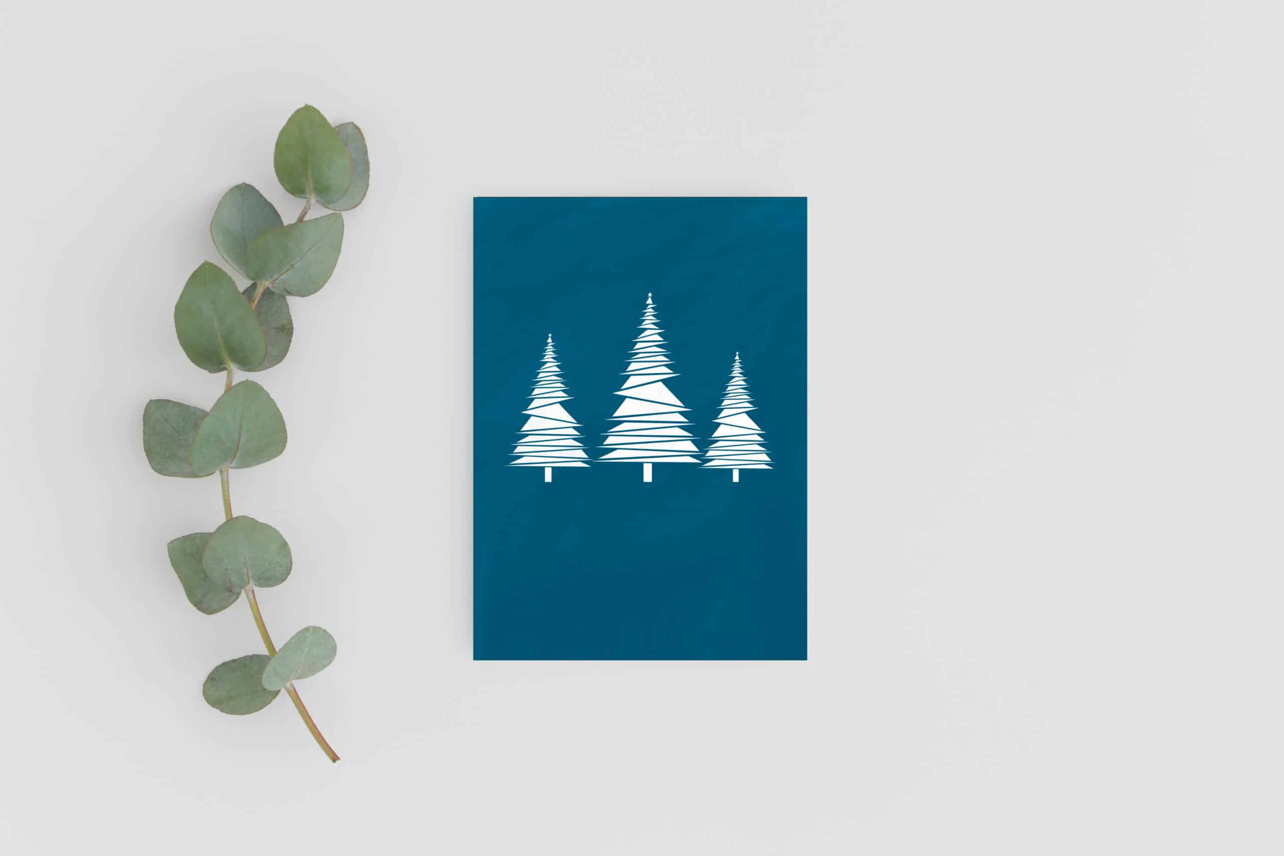 Teal Blue sustainable Christmas card with three snowy white trees in Geometric design