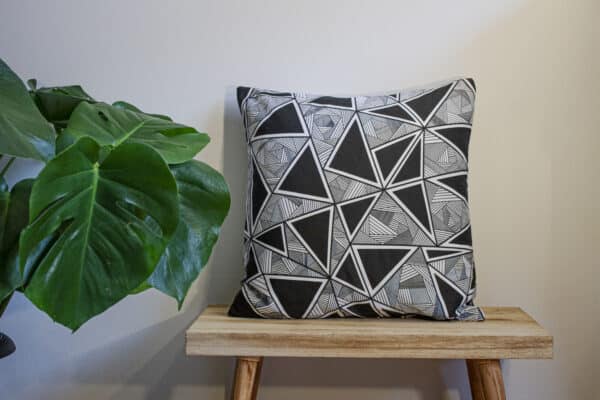 Black Throw Cushion and White Triangular, Geometric Pattern